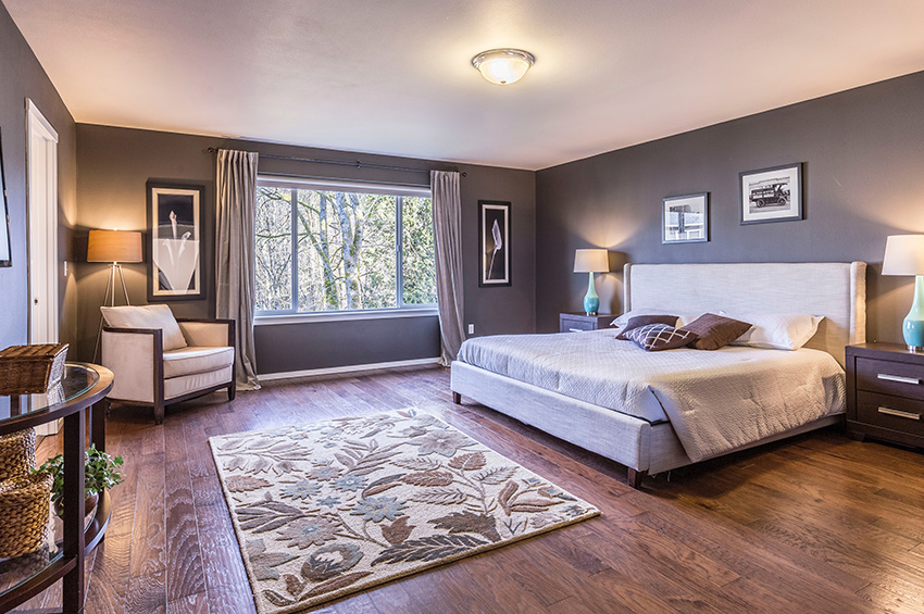 Dark wood-like laminate flooring in a master bedroom